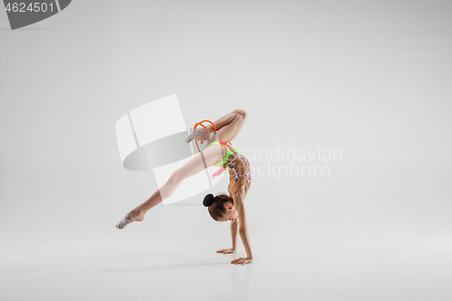 Image of The teenager girl doing gymnastics exercises isolated on white background