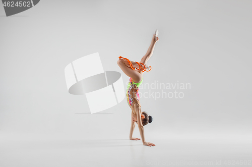 Image of The teenager girl doing gymnastics exercises isolated on white background