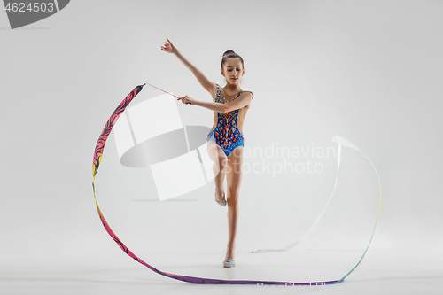 Image of The portrait of beautiful young brunette woman gymnast training calilisthenics exercise with ribbon