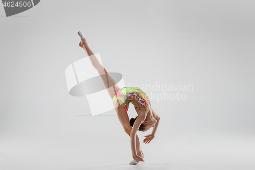 Image of The teenager girl doing gymnastics exercises isolated on white background