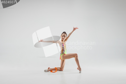 Image of The teenager girl doing gymnastics exercises isolated on white background