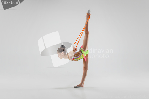 Image of The teenager girl doing gymnastics exercises isolated on white background