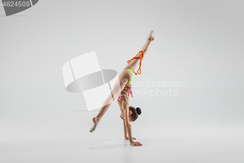 Image of The teenager girl doing gymnastics exercises isolated on white background