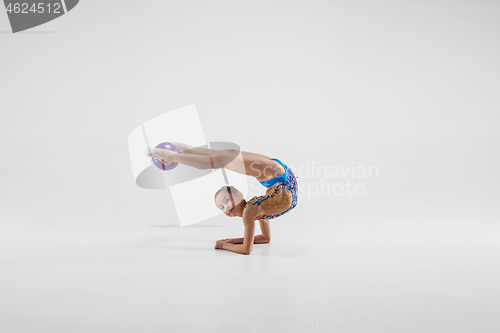 Image of The teenager girl doing gymnastics exercises isolated on white background