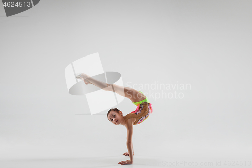 Image of The teenager girl doing gymnastics exercises isolated on white background