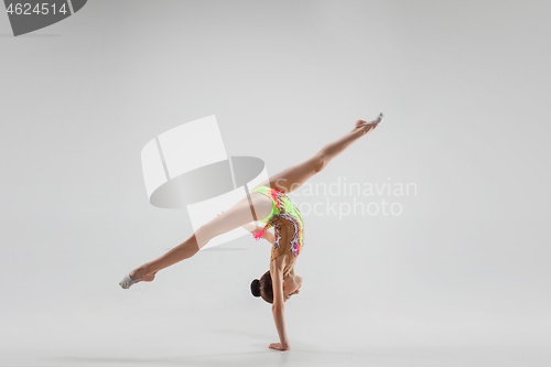 Image of The teenager girl doing gymnastics exercises isolated on white background