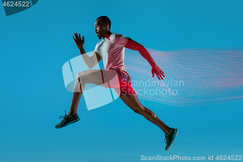 Image of Full length portrait of active young muscular running man,