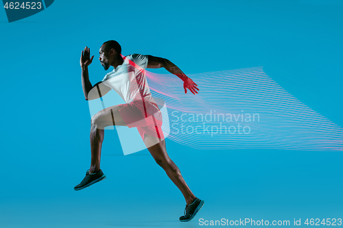 Image of Full length portrait of active young muscular running man,