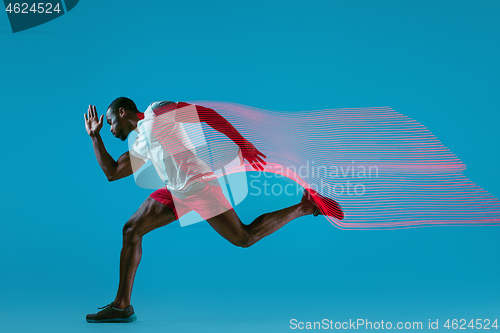 Image of Full length portrait of active young muscular running man,