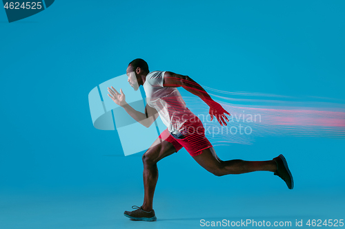 Image of Full length portrait of active young muscular running man,