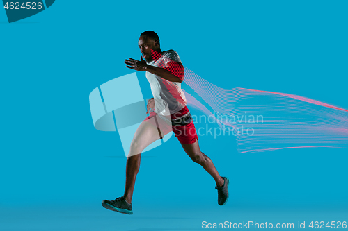 Image of Full length portrait of active young muscular running man,