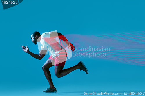 Image of Full length portrait of active young muscular running man,