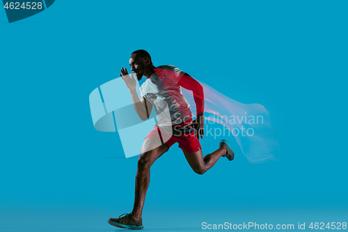 Image of Full length portrait of active young muscular running man,