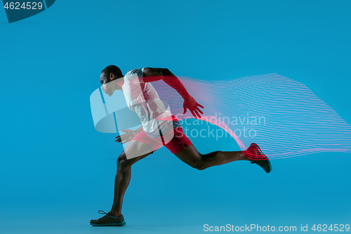 Image of Full length portrait of active young muscular running man,