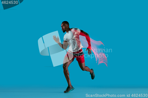 Image of Full length portrait of active young muscular running man,