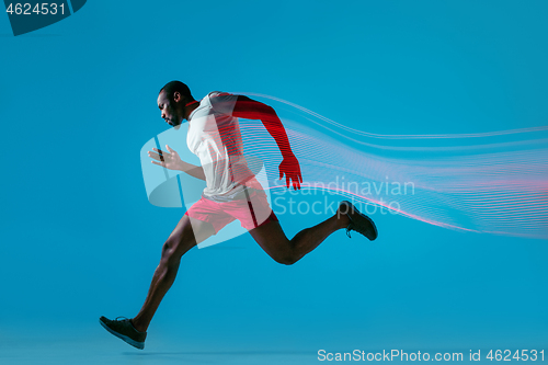 Image of Full length portrait of active young muscular running man,