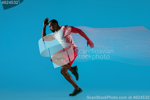 Image of Full length portrait of active young muscular running man,