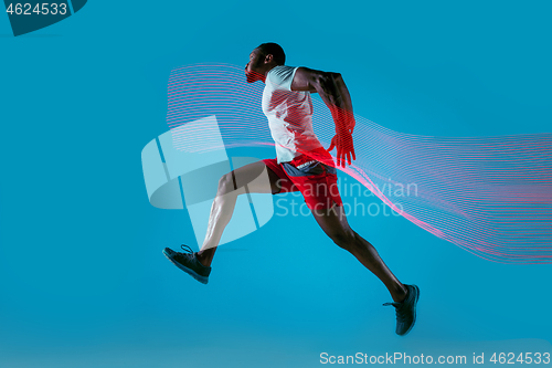 Image of Full length portrait of active young muscular running man,