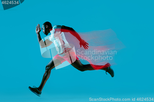 Image of Full length portrait of active young muscular running man,