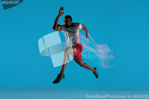 Image of Full length portrait of active young muscular running man,