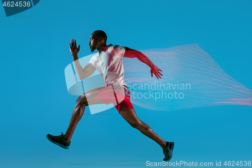 Image of Full length portrait of active young muscular running man,