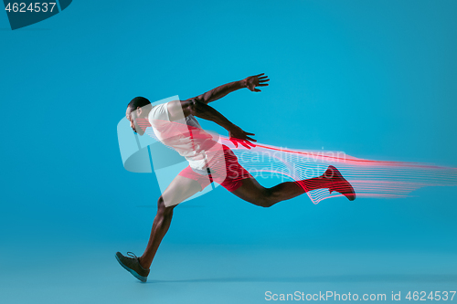 Image of Full length portrait of active young muscular running man,