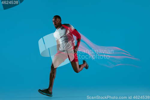 Image of Full length portrait of active young muscular running man,