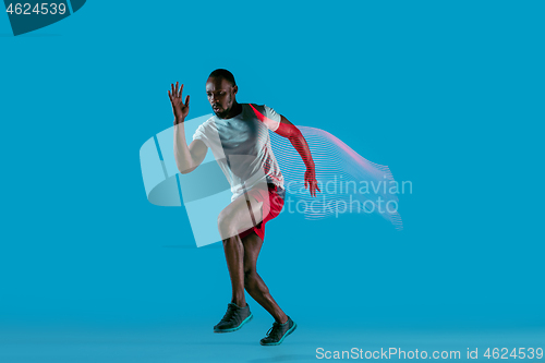 Image of Full length portrait of active young muscular running man,