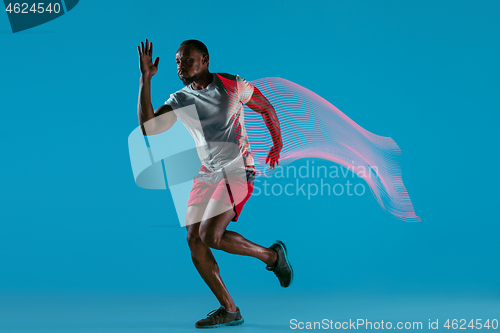 Image of Full length portrait of active young muscular running man,