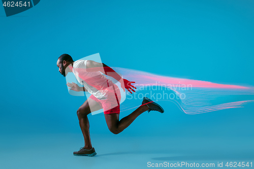 Image of Full length portrait of active young muscular running man,