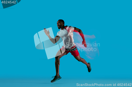 Image of Full length portrait of active young muscular running man,