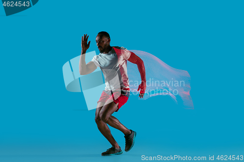 Image of Full length portrait of active young muscular running man,