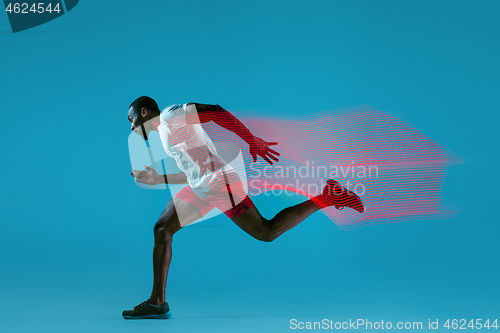 Image of Full length portrait of active young muscular running man,