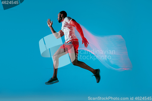 Image of Full length portrait of active young muscular running man,