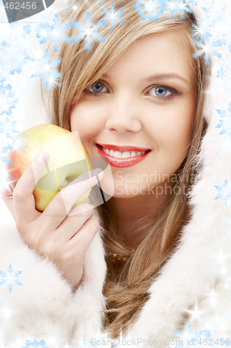 Image of lovely blond in fur with apple