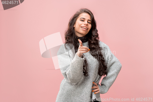 Image of The happy business woman point you and want you, half length closeup portrait on pink background.