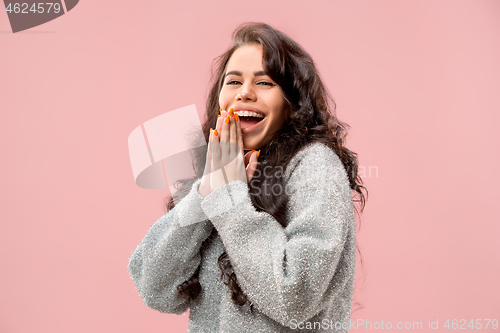 Image of Beautiful woman looking suprised isolated on pink