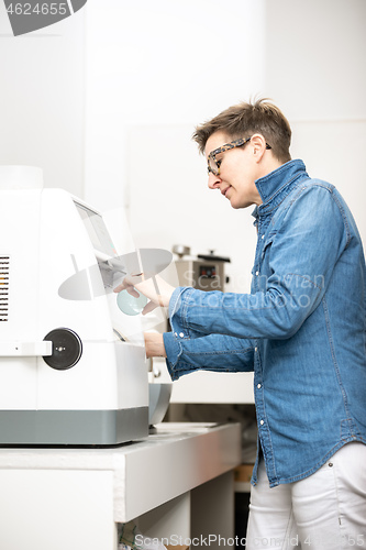 Image of woman hone the edge of the eyeglasses