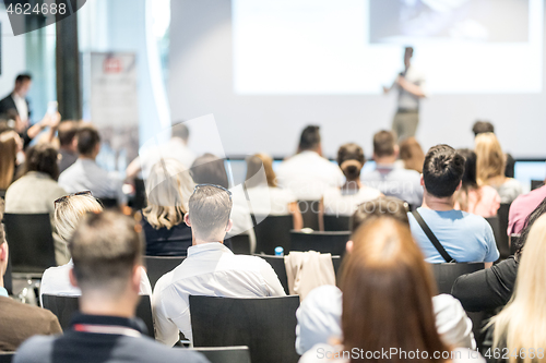 Image of Male business speaker giving a talk at business conference event.