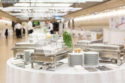 Image of Waiters prepare buffet before a coffee break at business conference meeting.