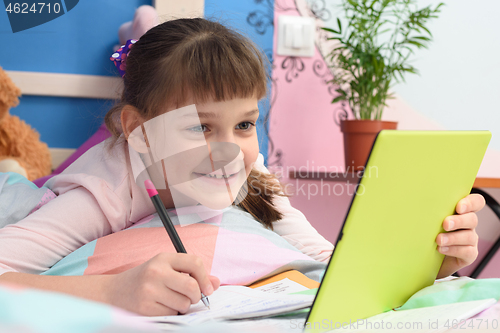 Image of Happy girl studying online at home using distance learning