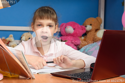 Image of Girl yawns from boring distance learning