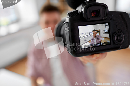 Image of close up of camera recording male video blogger