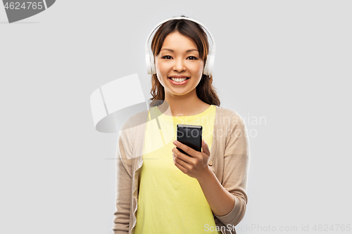 Image of asian woman in headphones listening to music