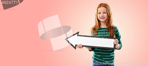 Image of smiling red haired girl with arrow showing to left