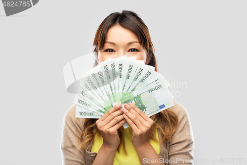 Image of asian woman with hundred euro money banknotes