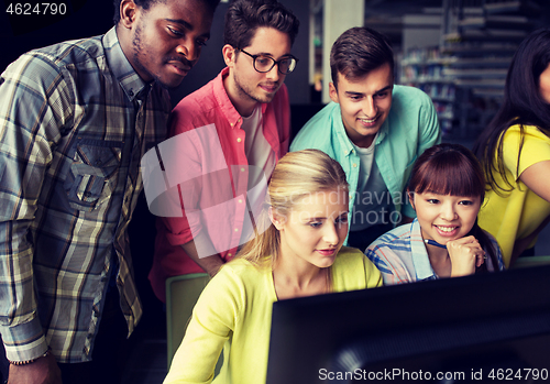 Image of international students with computers at library