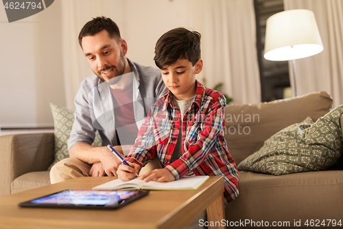 Image of father and son doing homework together