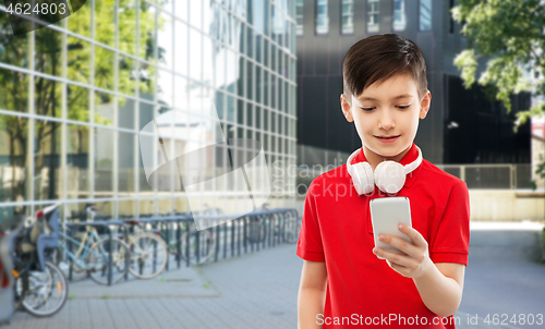 Image of boy in red t-shirt with headphones and smartphone