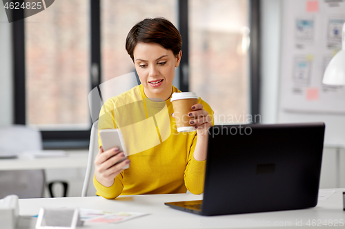 Image of businesswoman calling on smartphone at office